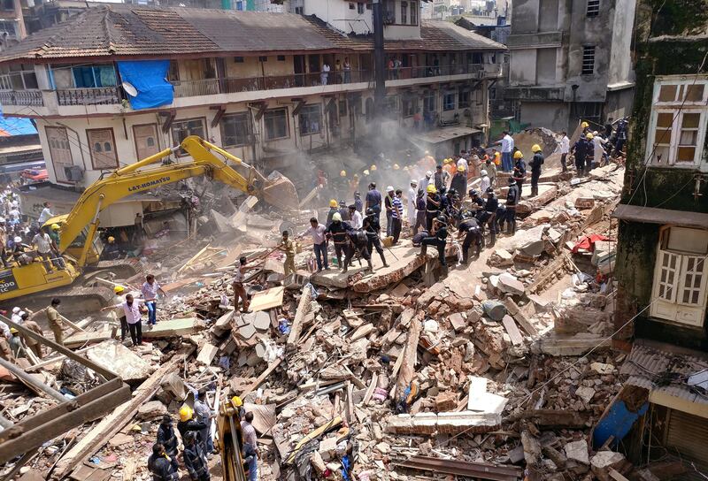 Firefighters and rescue workers search for survivors. Shailesh Andrade / Reuters