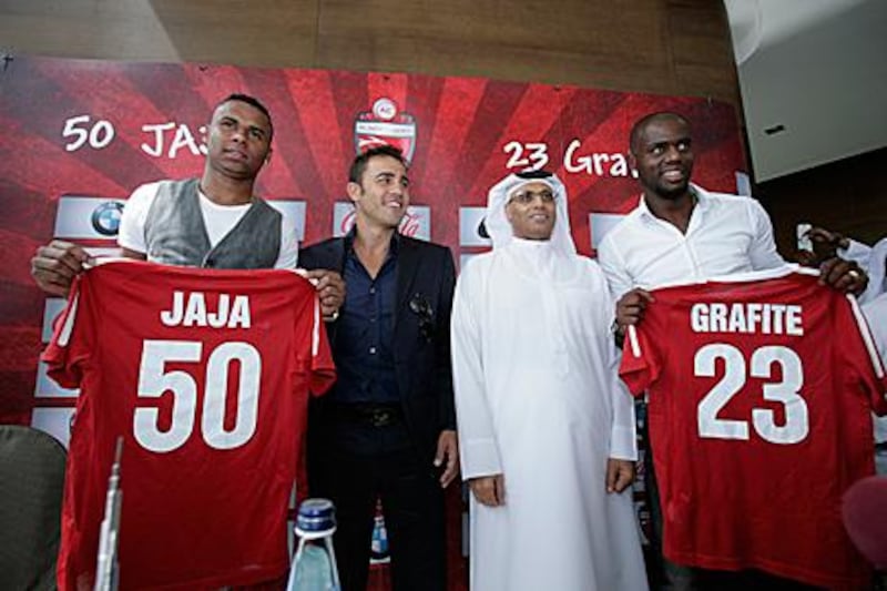 Fabio Cannavaro, second left, and Ahmed Khalifa Hammad, second right, stand alongside Al Ahli's two new signings, Jakson Avelino Coelho and Grafite, at their unveiling at the Burj Khalifa in Dubai.