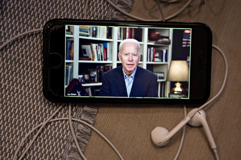 Former Vice President Joe Biden, 2020 Democratic presidential candidate, speaks during a virtual press briefing on a smartphone in this arranged photograph in Arlington, Virginia, U.S., on Wednesday, March 25, 2020. During the livestreamed news conference today, Biden said he didn't see the need for another debate, which the Democratic National Committee had previously said would happen sometime in April. Photographer: Andrew Harrer/Bloomberg