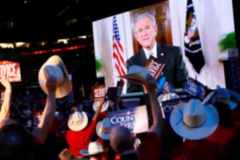 Texas delegates react as President Bush speaks via satellite at the Republican National Convention in St. Paul, Minn., Tuesday, Sept. 2, 2008.  (AP Photo/Charles Dharapak) *** Local Caption ***  MNDC144_APTOPIX_Republican_Convention.jpg