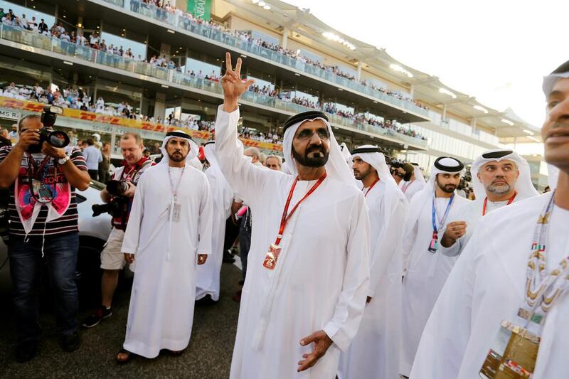 Sheikh Mohammed bin Rashid, Vice President of the UAE and Ruler of Dubai, waves to the main stand at Yas Marina Circuit. Hamad I Mohammed / Reuters