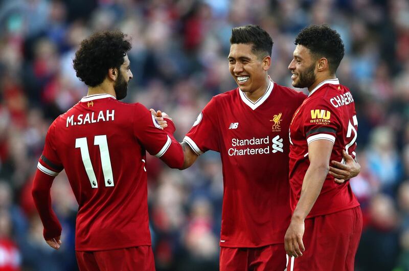 LIVERPOOL, ENGLAND - APRIL 14:  Roberto Firmino of Liverpool celebrates after scoring his sides third goal with Mohamed Salah ofLiverpool  and Alex Oxlade-Chamberlain of Liverpool during the Premier League match between Liverpool and AFC Bournemouth at Anfield on April 14, 2018 in Liverpool, England.  (Photo by Clive Brunskill/Getty Images)