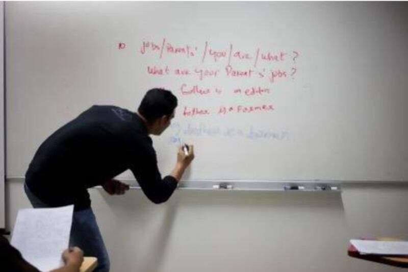 Men take part in a weekly English language class held at the American University of Dubai. Razan Alzayani / The National
