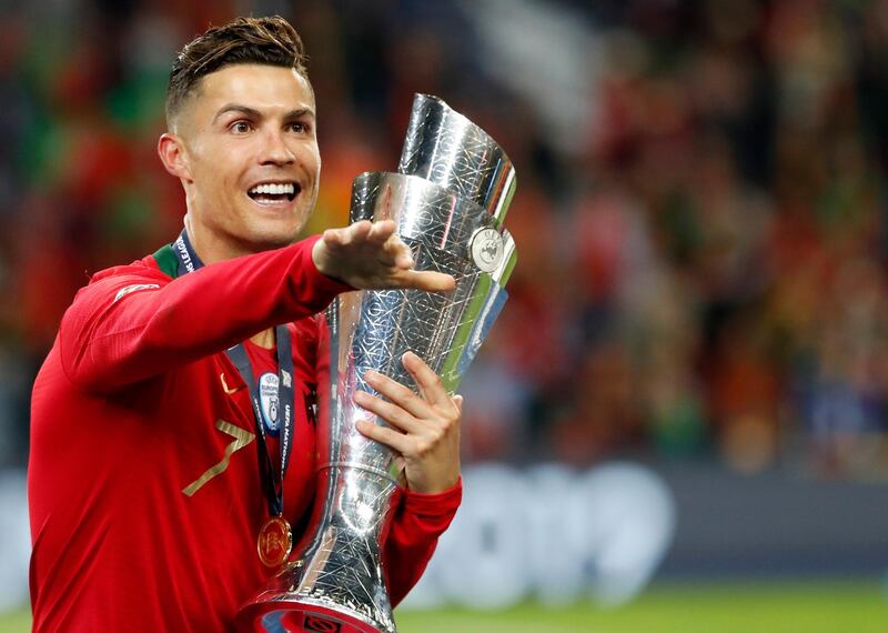 Portugal's Cristiano Ronaldo gestures as he holds the trophy after defeating the Netherlands 1-0 in the UEFA Nations League final soccer match at the Dragao stadium in Porto, Portugal, Sunday, June 9, 2019. (AP Photo/Armando Franca)