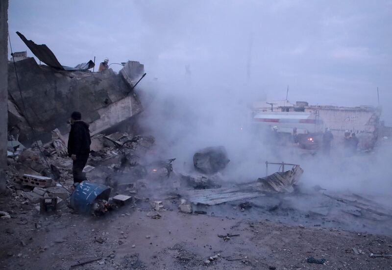 TOPSHOT - Members of the Syrian Civil Defence, also known as the White Helmets, fight a fire following a reported airstrike on the village of Kafr Nuran, in the western countryside of the northern province of Aleppo, on January 21, 2020. Russian air strikes killed at least 15 civilians in northwestern Syria, as renewed violence tightened the noose around the country's last major rebel-held bastion and deepened an already dire humanitarian crisis. / AFP / Aaref WATAD
