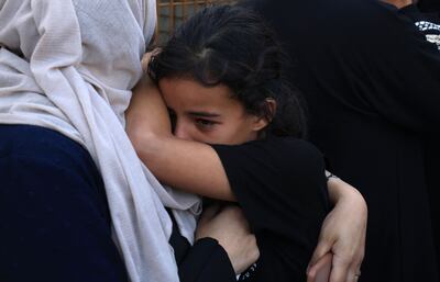 Palestinians weep as they prepare to bury a relative in Khan Younis. AFP