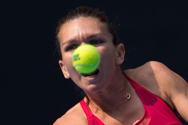 Simona Halep of Romania hits a return at the China Open in Beijing. Nicolas Asfouri / AFP Photo