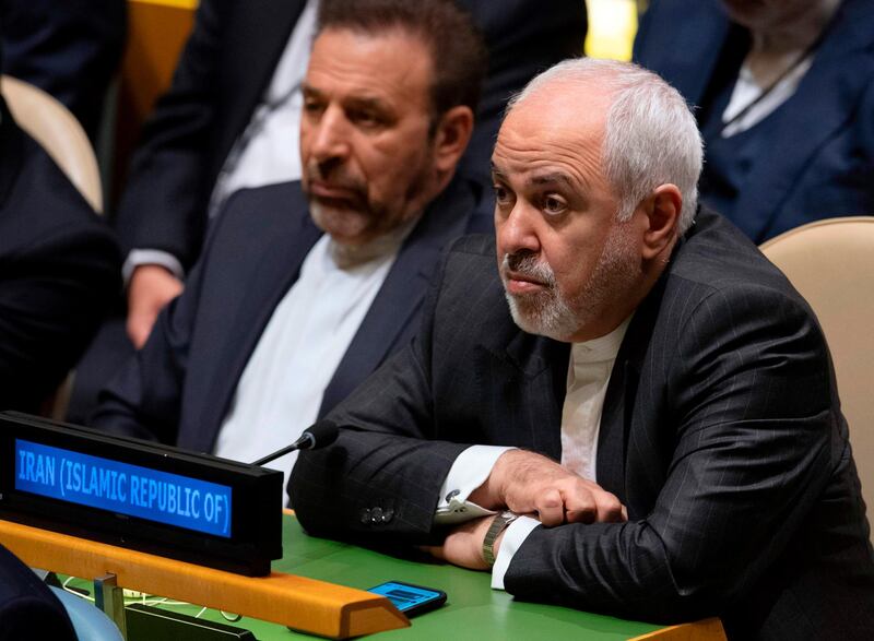 (FILES) In this file photo taken on September 25, 2019, Iran's Foreign Minister Mohammad Javad Zarif listens as Iran's President Hassan Rouhani speaks at the 74th session of the United Nations General Assembly in New York. The US State Department said on September 28, 2019, that it would only allow Minister Zarif to visit Majid Takht-Ravanchi, the country's UN ambassador, who is undergoing cancer treatment at a hospital in New York, if Tehran releases a detained US citizen. "Foreign Minister Zarif would like to visit a colleague who is in the hospital receiving world-class care. Iran has wrongfully detained several US citizens for years, to the pain of their families and friends they cannot freely visit," a State Department spokesperson told AFP. "We have relayed to the Iranian mission that the travel request will be granted if Iran releases a US citizen," the spokesperson said. / AFP / Don Emmert
