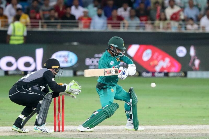 Pakistan cricketer Muhammad Hafeez (R) plays a shot during T20 cricket match between Pakistan and New Zealand at the Dubai Cricket Stadium in Dubai on November 4, 2018. / AFP / KARIM SAHIB
