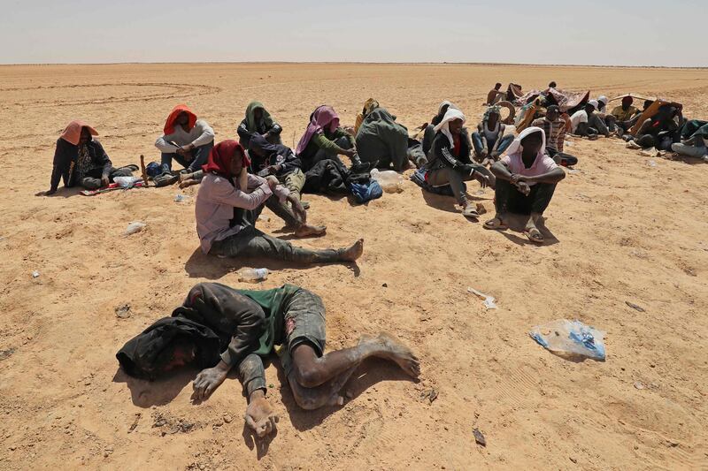Migrants from sub-Saharan Africa who claim Tunisian authorities abandoned them in the desert without water or shelter, near Libyan border town Al-Assah. AFP