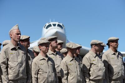 Russian Air Force personnel stand in front of a Tupolev Tu-160 strategic long-range heavy supersonic bomber aircraft upon landing at Maiquetia International Airport, just north of Caracas, on December 10, 2018. Venezuela and Russia will hold joint air force exercises for the defense of the South American country, Defense Minister Vladimir Padrino announced on Monday. Padrino, whose government often accuses the United States of plotting military action against it, made the announcement as he welcomed about 100 Russian pilots and other personnel upon their arrival in Caracas aboard various military aircraft.
 / AFP / Federico PARRA
