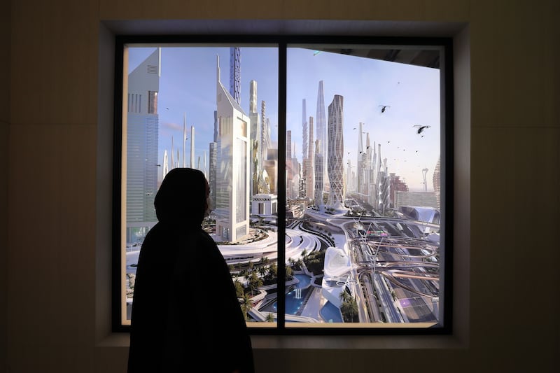 A museum visitor looks out a virtual window to an imagined future Dubai cityscape. Chris Whiteoak / The National
