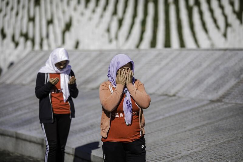 Bosnian Muslim women pray as they visit the cemetery for victims of Srebrenica genocide, in Potocari near Srebrenica, Bosnia and Herzegovina. Getty Images