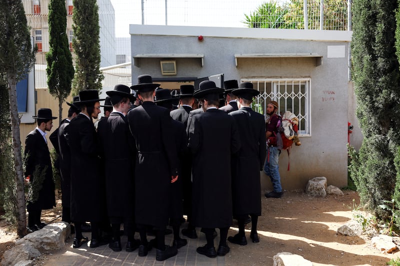 Ultra-Orthodox Jews line up at a draft office in Kiryat Ono, Israel, to process their exemptions from mandatory military service. Reuters