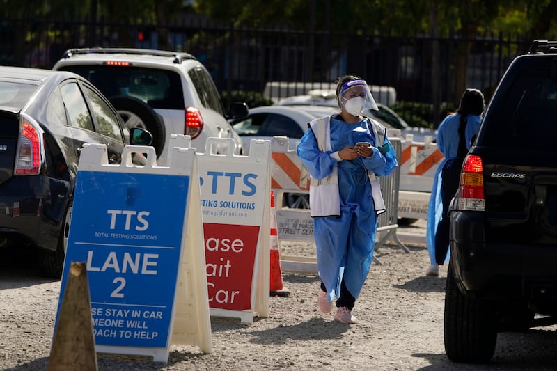 Workers wear protective equipment at a Covid-19 testing site in the Boyle Heights section of Los Angeles. AP