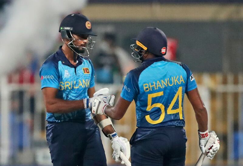 Sri Lanka's Bhanuka Rajapaksa, right, with captain Dasun Shanaka after hitting a boundary. AP