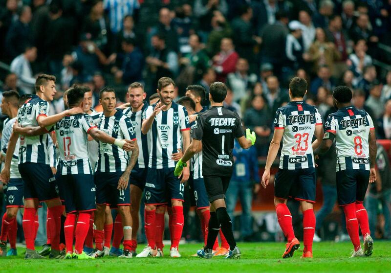Monterrey' players celebrate after the end of the game against Santos during the first leg of quarterfinal of Mexican Apertura 2019 tournament football, match at the BBVA Bancomer stadium in Monterrey, Mexico, on November 28, 2019.  / AFP / Julio Cesar AGUILAR
