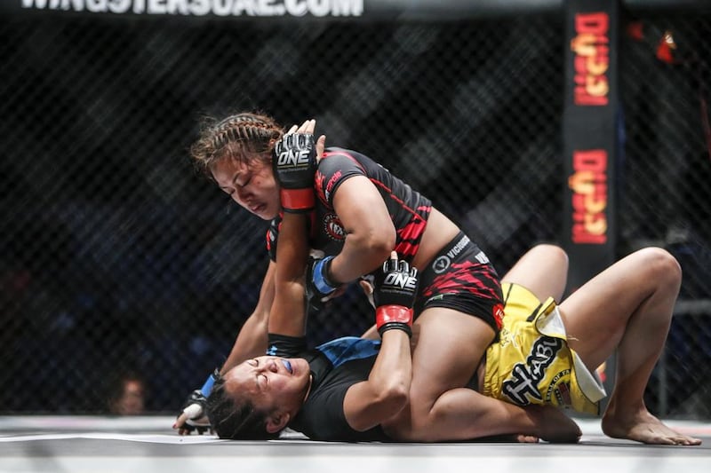 The One Fighting Championship "Reign Of Champions" mixed martial arts tournament held at the Dubai World Trade Center. Anna Julaton (Philippines, yellow shorts) vs Ann Osman (Malaysia, black shorts). Antonie Robertson / The National