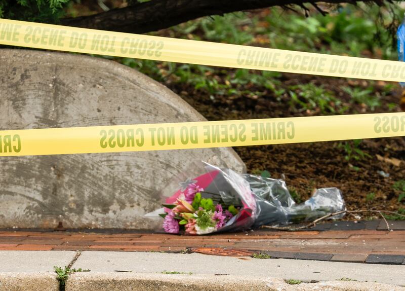 Flowers line the sidewalk near the scene of the mass shooting. EPA