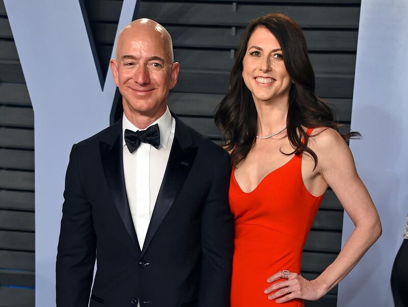 FILE - In this March 4, 2018 file photo, Jeff Bezos and wife MacKenzie Bezos arrive at the Vanity Fair Oscar Party in Beverly Hills, Calif. Jeff Bezos and MacKenzie, announced Thursday, April 4, 2019, in a series of tweets that they have finalized their divorce, ending a 25-year marriage that played a role in the creation of the online shopping giant. (Photo by Evan Agostini/Invision/AP, File)