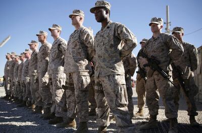 FILE - In this Jan. 15, 2018 file photo, U.S. Marines stand guard during the change of command ceremony at Task Force Southwest military field in Shorab military camp of Helmand province, Afghanistan. The Pentagon is developing plans to withdraw up to half of the 14,000 American troops serving in Afghanistan, U.S. officials said Thursday, Dec. 20, 2018, marking a sharp change in the Trump administration's policy aimed at forcing the Taliban to the peace table after more than 17 years of war. (AP Photo/Massoud Hossaini, File)