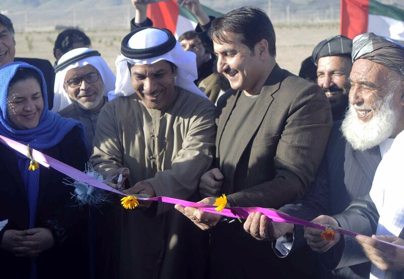 Juma Al Kaabi (centre left), UAE's Ambassador to Afghanistan, cuts a ribbon with Dr Humayoon Azizi (centre right), the Governor of Kandahar province, during a ceremony in Kandahar, Afghanistan. Kandahar Gov Office / EPA