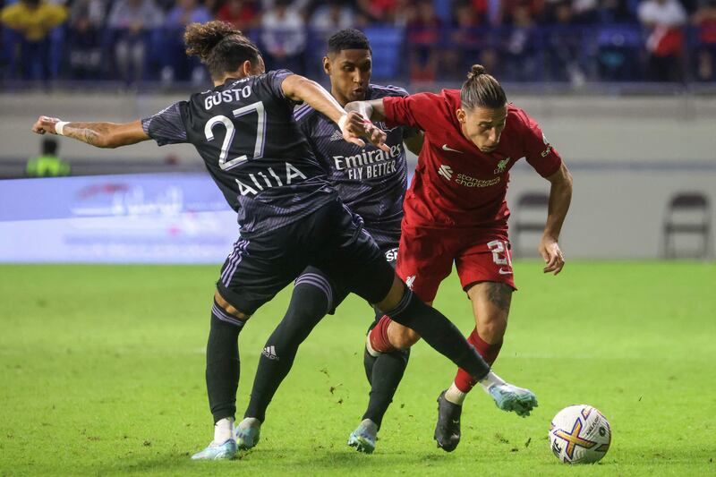 Lyon's Malo Gusto tries to stop Liverpool's Kostas Tsimikas. AFP