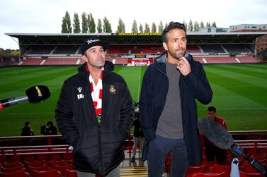 FILE - Wrexham co-chairmen Rob McElhenney, left, and Ryan Reynolds during a press conference at the Racecourse Ground, Wrexham, Wales, on Oct.  28, 2021.  Soccer sensation Wrexham AFC is coming to America.  The fifth-tier Welsh side, which has become a global fan favorite since Hollywood stars Reynolds and McElhenney bought it and then launched a documentary series, "Welcome to Wrexham," will play Manchester United in a friendly on July 25, 2023, at 35,000-seat Snapdragon Stadium in San Diego.  (Peter Byrne / PA via AP, File)