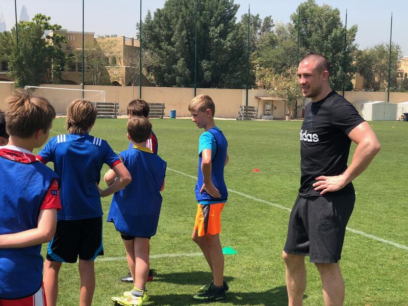 Mike Brown gets involved in the training session at Dubai College.