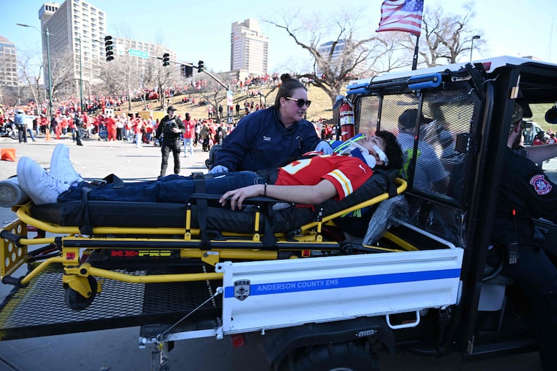 A paramedic attends to an injured person after shots were fired near the Kansas City Chiefs' Super Bowl victory parade, in Kansas City, Missouri. AFP