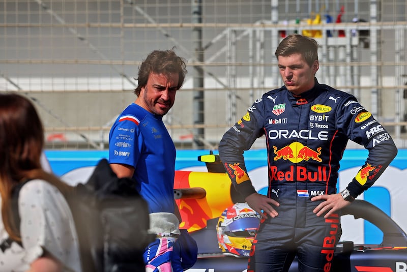 Alpine driver Fernando Alonso speaks with Red Bull's Max Verstappen. AFP
