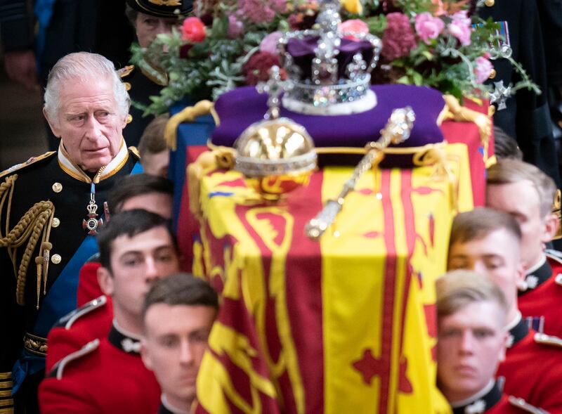 King Charles follows behind the coffin of Queen Elizabeth as it is carried out of Westminster Abbey after her state funeral in September 2022