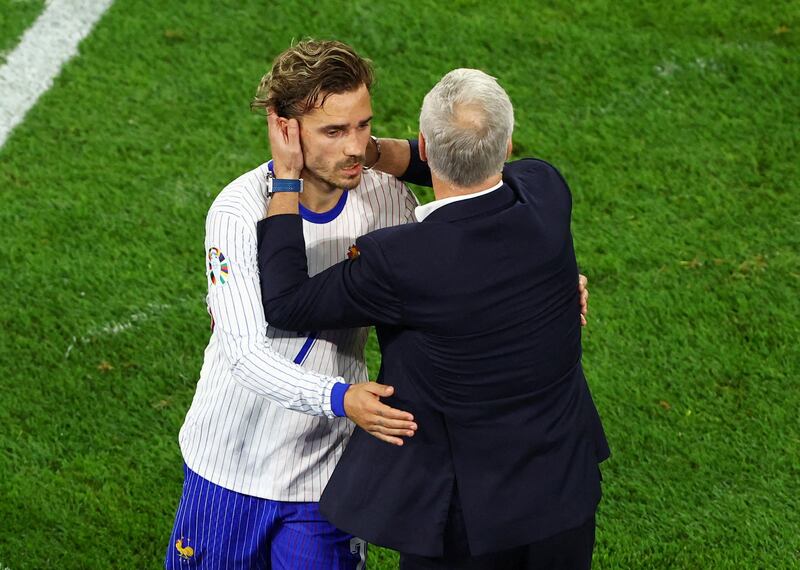 France's Antoine Griezmann embraces coach Didier Deschamps after being substituted against Austria. Reuters