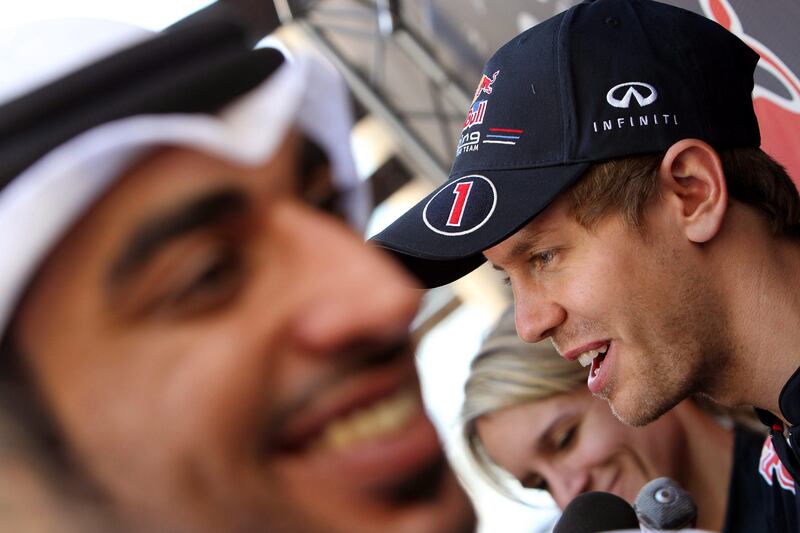 epa02998635 German Formula One world champion Sebastian Vettel (R) of Red Bull Racing talks to journalists at Yas Marina Circuit in Abu Dhabi, United Arab Emirates, 10 November 2010. The 2011 Formula One Grand Prix of Abu Dhabi takes place on 13 November.  EPA/ALI HAIDER *** Local Caption ***  02998635.jpg