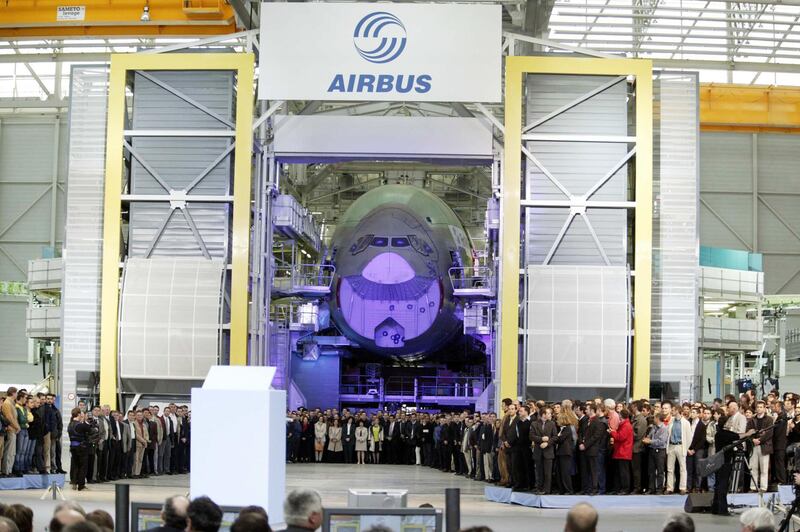 Workers gather in front of the nose cone of an Airbus A380 at the opening ceremony for the new final-assembly plant at Airbus's Toulouse. Bloomberg