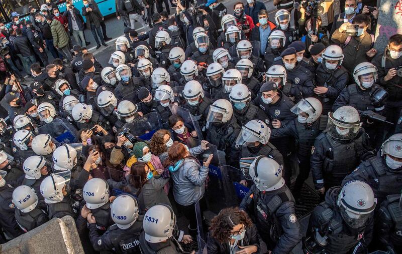 TOPSHOT - Turkish police officers detain protestors during a rally in support of Bogazici University students protesting against the appointment of Melih Bulu, a ruling Justice and Development Party (AKP) loyalist, as the new rector of the university, in Istanbul on February 4, 2021. Students are protesting against the Turkish president's decision last month (January 1) to name party loyalist Melih Bulu to head Istanbul's elite Bogazici University, with many  students seeing his appointment as a part of the president's broader push to seize control of various facets of Turks' daily lives while in power for the past 18 years.
 / AFP / Bulent Kilic
