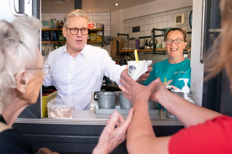 Mr Starmer serves ice cream to day trippers on Barry seafront in South Wales. PA