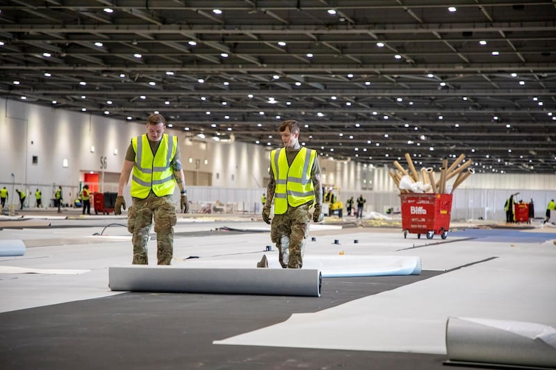 Soldiers from 1 Royal Anglian Regiment assist with the construction of the new NHS Nightingale Hospital. Courtesy Reuters