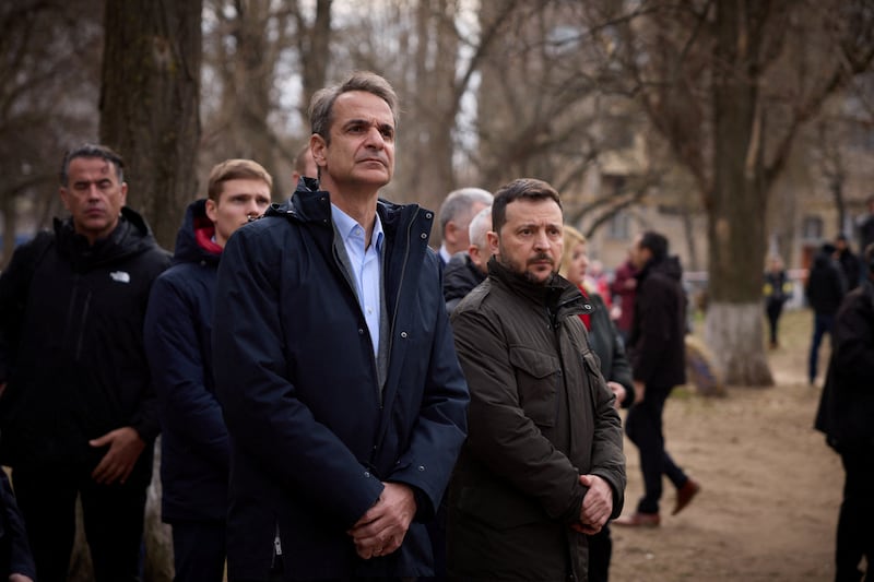 Ukraine's President Volodymyr Zelenskyy and Greek Prime Minister Kyriakos Mitsotakis visit a makeshift memorial to the victims of previous day's drone strike that heavily damaged an apartment building, amid Russia's attack on Ukraine, in Odesa. Reuters