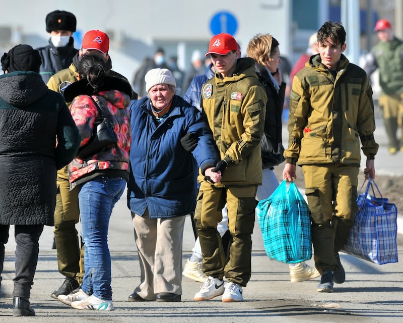 Residents of the self-proclaimed Donetsk People's Republic cross from Ukraine into Russia, after it was announced that women and children would be led to the Rostov region due to rising tension in the area. EPA