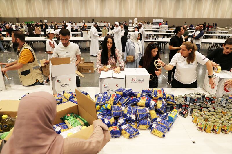 Volunteer pack aid in Expo City Dubai on Sunday to be delivered to those impacted by the earthquake in Turkey and Syria. All photos: Pawan Singh / The National