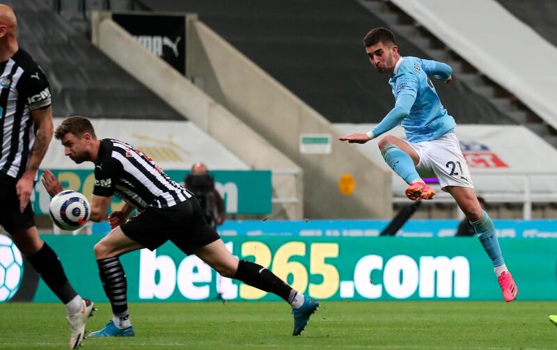 epa09200595 Manchester City's Ferran Torres (R) scores a goal during the English Premier League soccer match between Newcastle United and Manchester City in Newcastle, Britain, 14 May 2021.  EPA/Scott Heppell / POOL EDITORIAL USE ONLY. No use with unauthorized audio, video, data, fixture lists, club/league logos or 'live' services. Online in-match use limited to 120 images, no video emulation. No use in betting, games or single club/league/player publications.