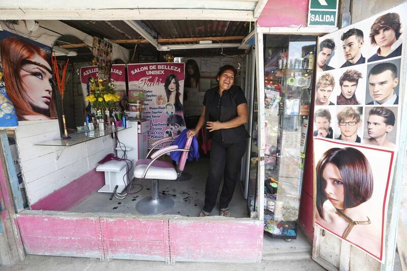 Fabiola Tuesta, 54, in her beauty salon in Gosen City. Tuesta said that not long ago nobody in Gosen had money to spend on luxuries like hair styling. Now she charges the equivalent of $1.79 for a cut and is the only hairdresser in the neighbourhood. Mariana Bazo / Reuters