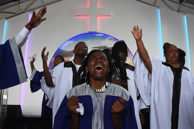 Choir members sing during the Sunday mass without wearing masks and social distancing at Ufunuo na Uzima Church in Dar es Salaam. For more than six months, Tanzania has tried to convince the world it has been cured of the coronavirus, through prayer, while refusing to take measures to curb its spread. However dissent is mounting along with deaths attributed to "pneumonia", with even a politician in semi-autonomous Zanzibar admitting he has the virus. AFP
