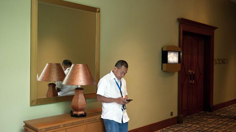Malaysian Airlines Group chief executive Ahmad Jauhari Yahya checks his mobile phone outside a press conference room near the Kuala Lumpur International Airport (KLIA) in Sepang. Mohd Rasfan / AFP Photo