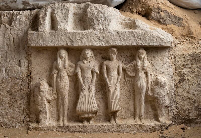 A carving of six sculpted figures in a small funerary chapel, the owner of which is yet unknown. It depicts two men in the centre, each accompanied by their wives holding the hands of children. Photo: Ministry of Tourism and Antiquities Facebook