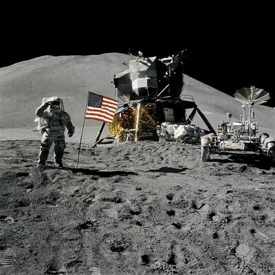 FILE PHOTO: Astronaut James Irwin, lunar module pilot, gives a military salute while standing beside the U.S. flag during Apollo 15 lunar surface extravehicular activity (EVA) at the Hadley-Apennine landing site on the moon, August 1, 1971. NASA/David Scott/Handout via REUTERS/File Photo