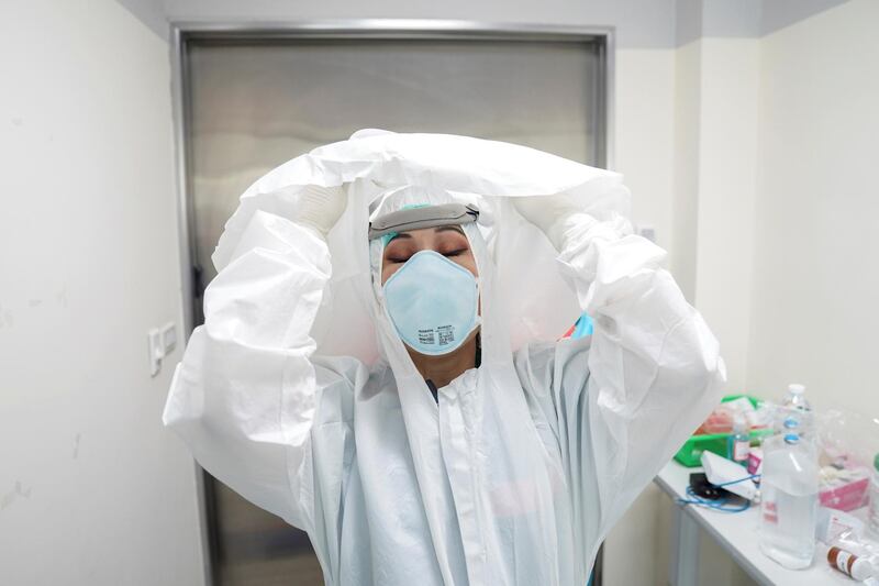 A doctor takes off her personal protection equipment (PPE) after treating a patient suffering from Covid-19 in the Intensive Care Unit at the King Chulalongkorn Memorial Hospital in Bangkok, Thailand. Reuters