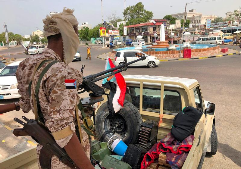 A fighter of the UAE-trained Security Belt Force, dominated by backers of the the Southern Transitional Council (STC) which seeks independence for south Yemen, mans the turret of a technical (pickup truck mounted with an anti-aircraft gun) displaying the southern Yemeni separatist flag in Khor Maksar in the centre of Yemen's second city of Aden on August 12, 2019. The head of Yemen's separatist movement said he was ready to take part in Saudi-brokered peace talks after clashes with pro-government forces killed dozens in the port city. Southern Transitional Council (STC) leader Aidarus al-Zubaidi had said late on August 11 that he was committed to a ceasefire in Aden, where the separatists have seized the presidential palace and army camps. / AFP / Nabil HASAN
