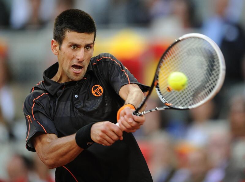 MADRID, SPAIN - MAY 08:  Novak Djokovic of Serbia plays a double handed backhand to Rafael Nadal of Spain in his final match during day eight of the Mutua Madrilena Madrid Open Tennis on May 8, 2011 in Madrid, Spain. Djokovic won his match in straight sets.  (Photo by Jasper Juinen/Getty Images)